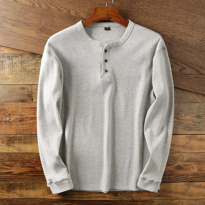 Casual long-sleeve Henley shirt offering a breathable and comfortable design, perfect for summer days.