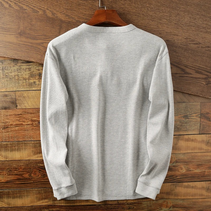 Casual long-sleeve Henley shirt offering a breathable and comfortable design.