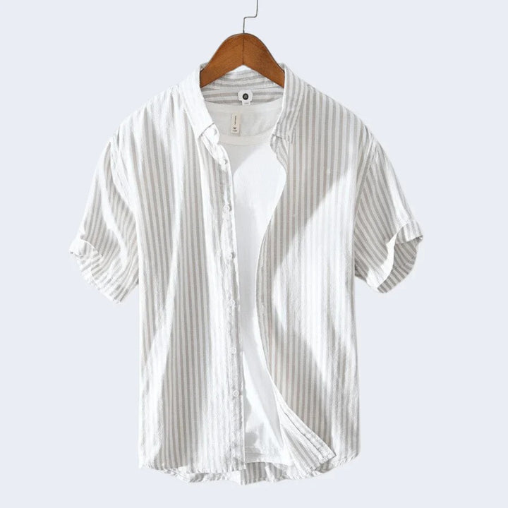  Classic men's beach shirt made from breathable and lightweight fabric, perfect for staying cool and stylish on summer days.
