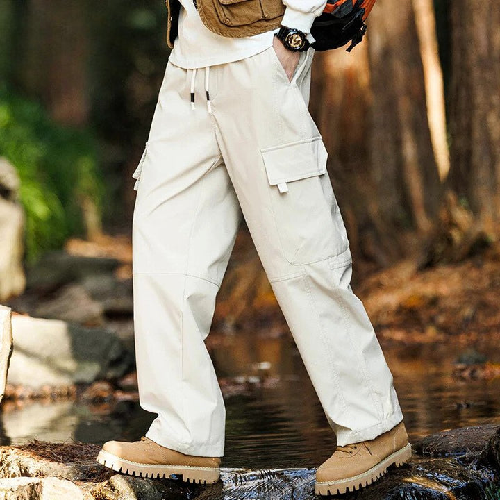 Men’s casual waterproof cargo pants with breathable fabric and multiple pockets, ideal for outdoor adventures and everyday wear.