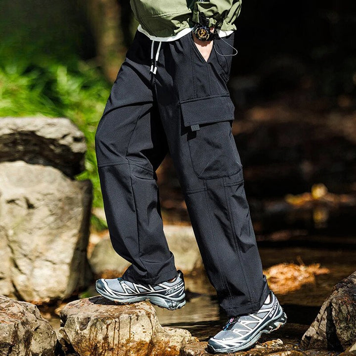 Men’s casual waterproof cargo pants with breathable fabric and multiple pockets, ideal for outdoor adventures and everyday wear.