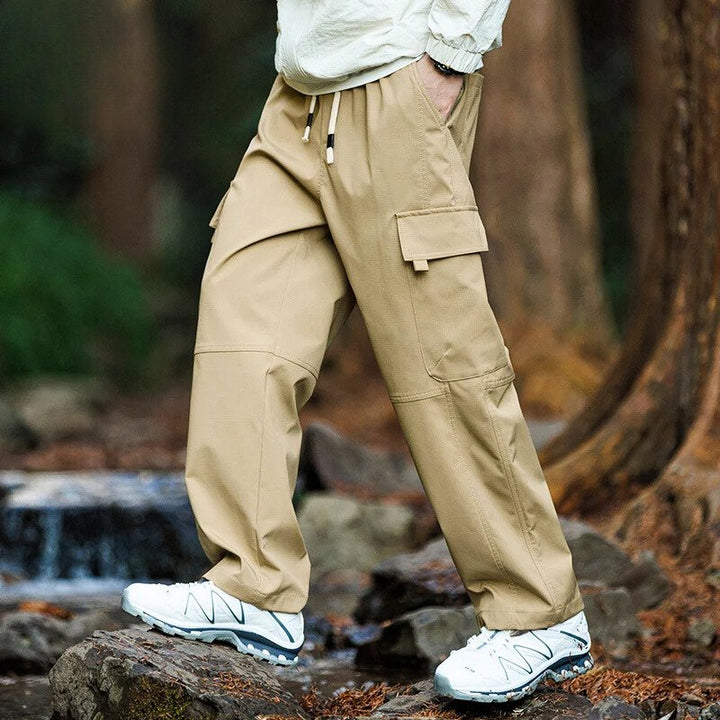Men’s casual waterproof cargo pants with breathable fabric and multiple pockets, ideal for outdoor adventures and everyday wear.