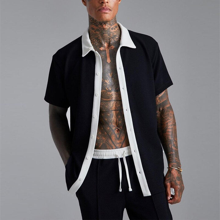 Man wearing a fashionable shirt and short summer set, perfect for staying cool and stylish during warm weather.