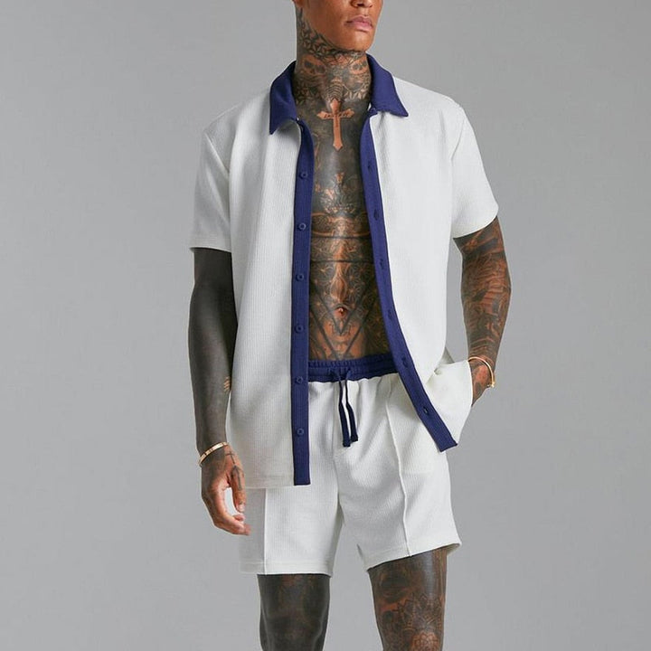 Man wearing a fashionable shirt and short summer set, perfect for staying cool and stylish during warm weather.