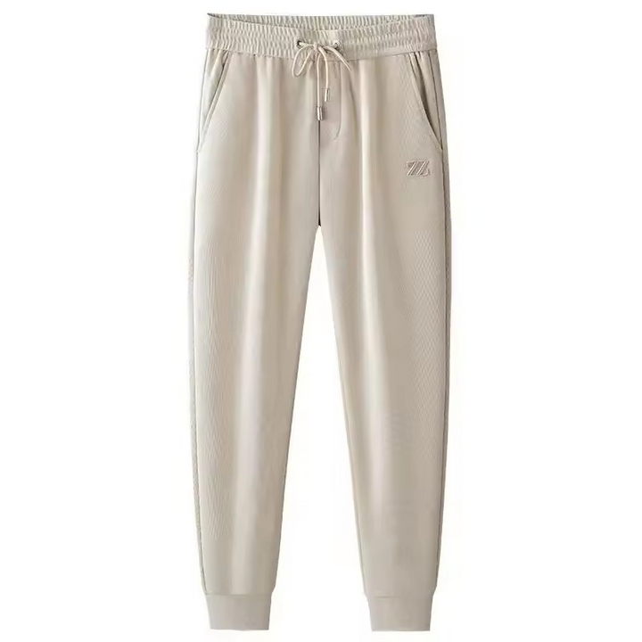 Men's premium jogging pants with a relaxed fit and breathable fabric, perfect for workouts or casual summer days.
